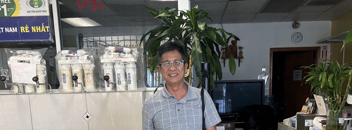 Owner of Phoenix Drinking Water smiling inside the shop